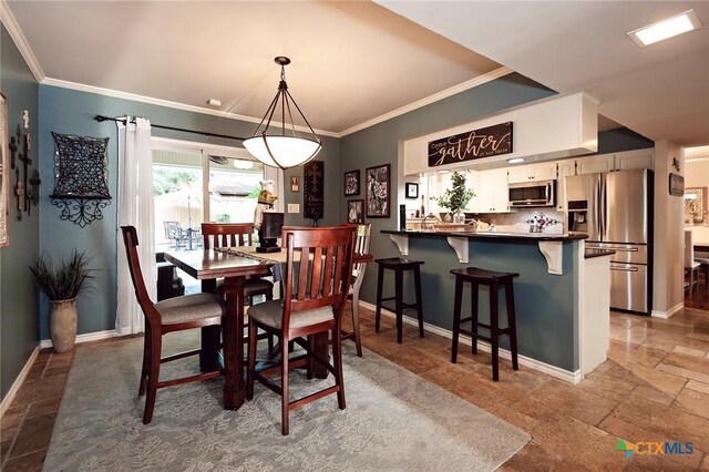 3501 Grizzly Bear Trl, Temple, TX 76502 - dining room featuring stone tile flooring, crown molding, and baseboards