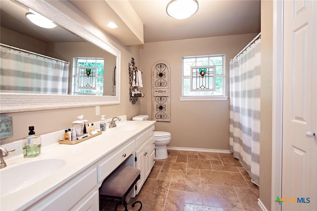 3501 Grizzly Bear Trl, Temple, TX 76502 - bathroom with healthy amount of natural light, baseboards, stone tile flooring, and toilet