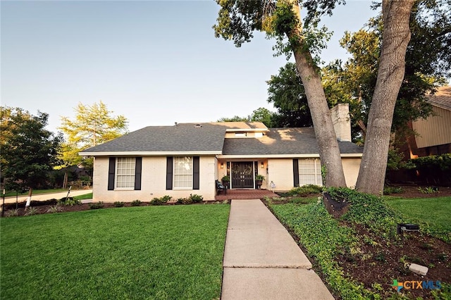 3501 Grizzly Bear Trl, Temple, TX 76502 - view of front facade with a front lawn, brick siding, roof with shingles, and a chimney
