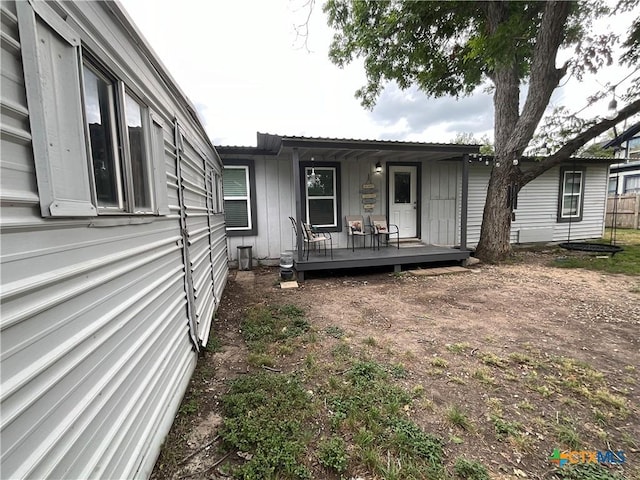 1210 N Milam St, Seguin, TX 78155 - rear view of property with board and batten siding and a wooden deck
