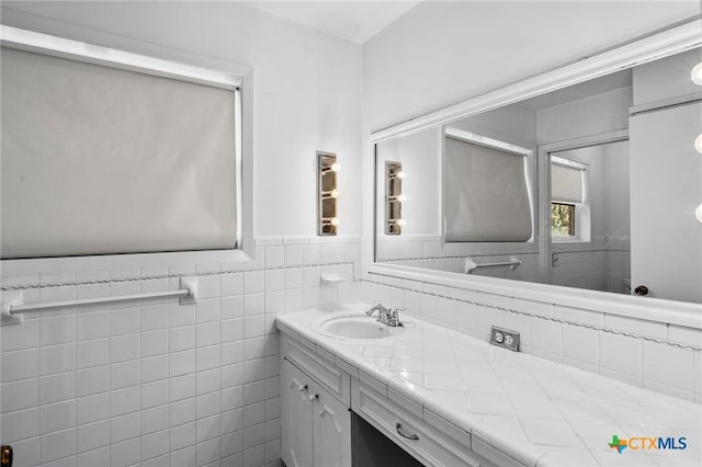 104 Salisbury Ln, Victoria, TX 77904 - bathroom with a wainscoted wall, vanity, and tile walls