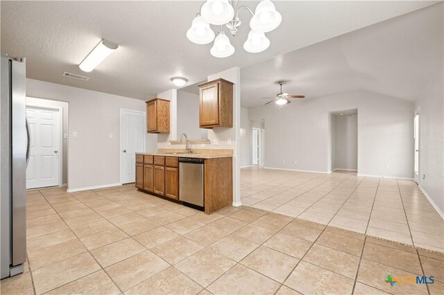503 Chrislyn St, Troy, TX 76579 - kitchen featuring stainless steel appliances, light tile patterned flooring, ceiling fan, light countertops, and brown cabinets
