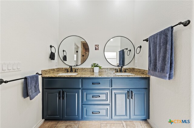 bathroom featuring tile patterned flooring and vanity