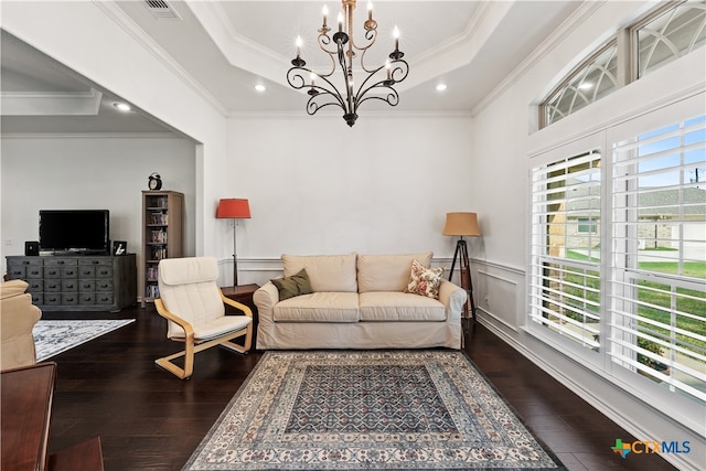 living room featuring a tray ceiling, crown molding, dark wood-type flooring, and a notable chandelier