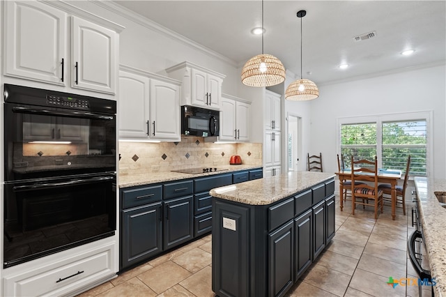 kitchen with white cabinetry, a center island, hanging light fixtures, tasteful backsplash, and black appliances