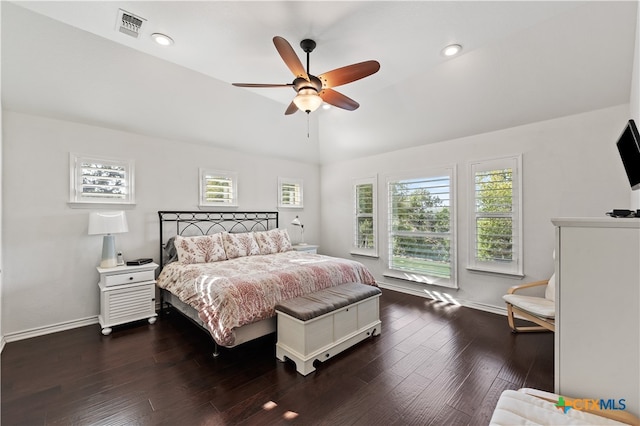 bedroom featuring ceiling fan, dark hardwood / wood-style flooring, and vaulted ceiling