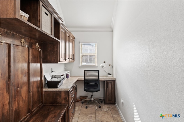 tiled home office with built in desk and ornamental molding