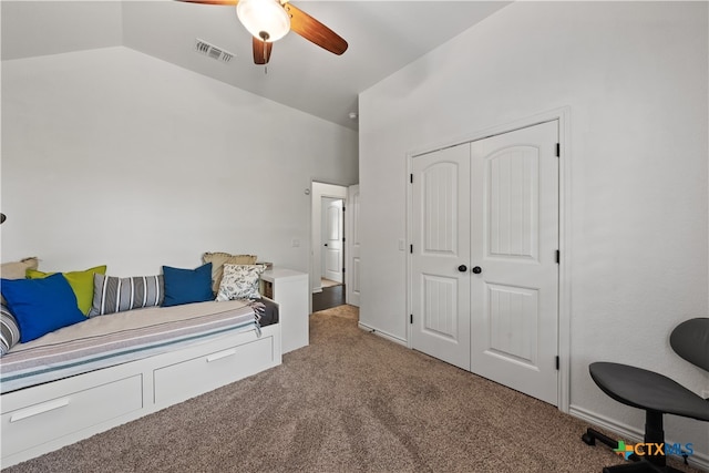 interior space featuring ceiling fan, light colored carpet, and lofted ceiling