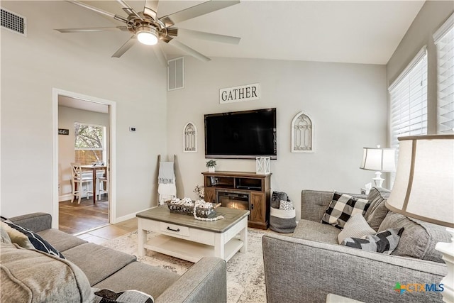 living room with vaulted ceiling and ceiling fan