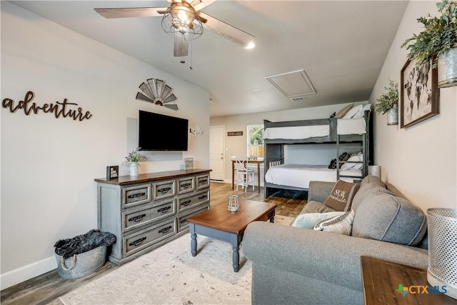 living room with wood-type flooring and ceiling fan