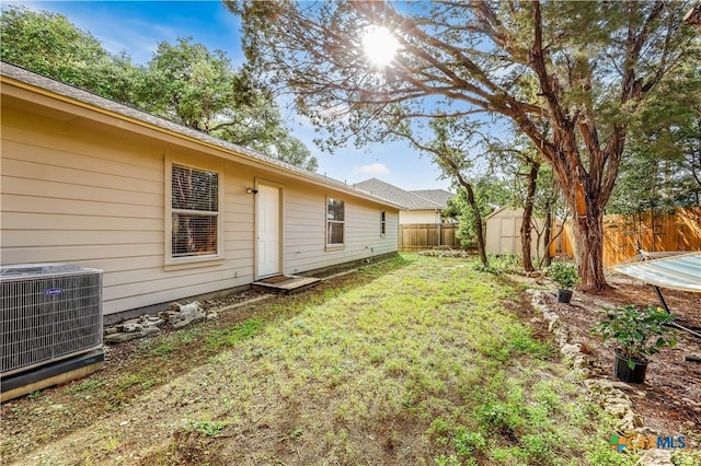 view of yard with a shed and central AC