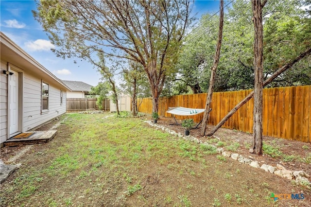 view of yard with a storage unit