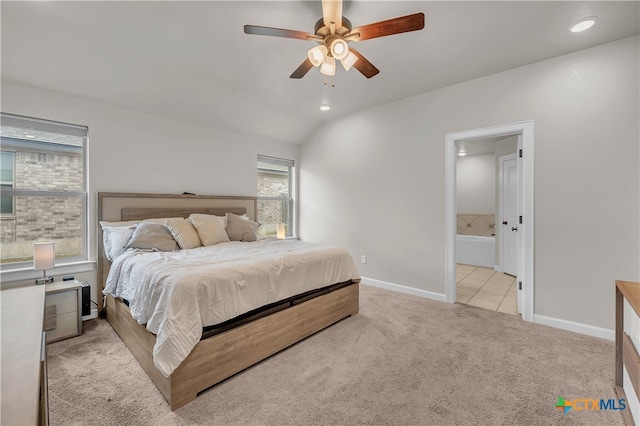 carpeted bedroom featuring lofted ceiling, connected bathroom, and ceiling fan