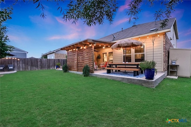 272 Adoquin Trl, Buda, TX 78610 - back of property at dusk featuring a patio area and a ceiling fan