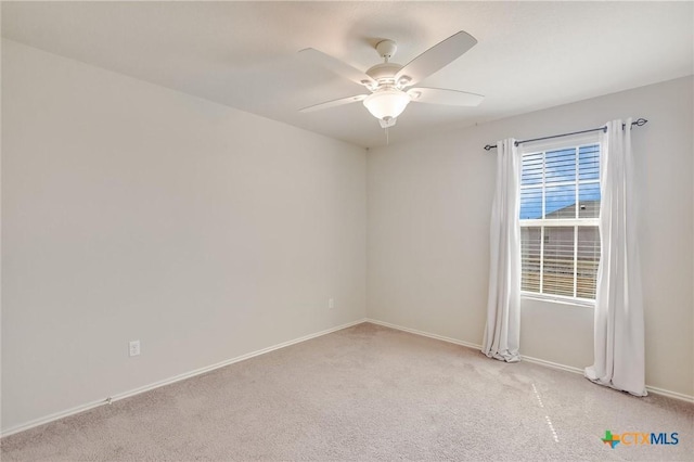 272 Adoquin Trl, Buda, TX 78610 - spare room with light carpet, ceiling fan, and baseboards