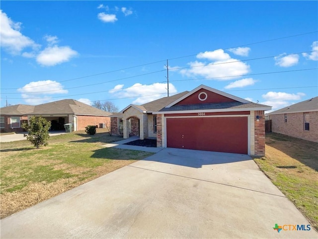 5004 Imperial Eagle Dr, Killeen, TX 76549 - ranch-style house featuring a garage, driveway, brick siding, and a front yard