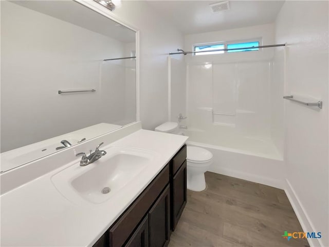 5004 Imperial Eagle Dr, Killeen, TX 76549 - bathroom featuring visible vents, toilet, wood finished floors, shower / bath combination, and vanity