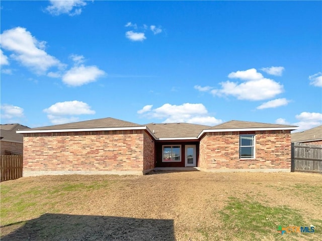 5004 Imperial Eagle Dr, Killeen, TX 76549 - rear view of house with a yard, brick siding, and fence