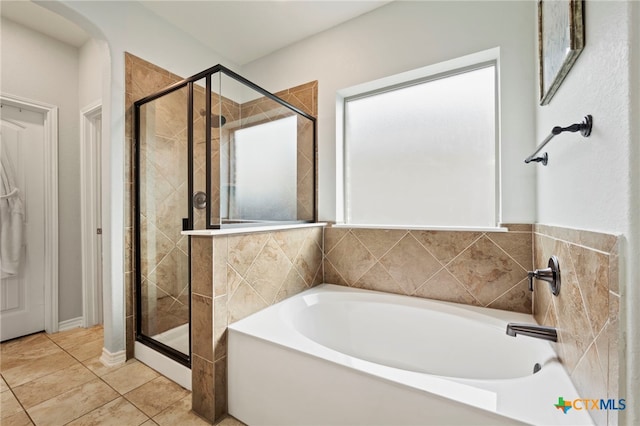 bathroom with a garden tub and a stall shower