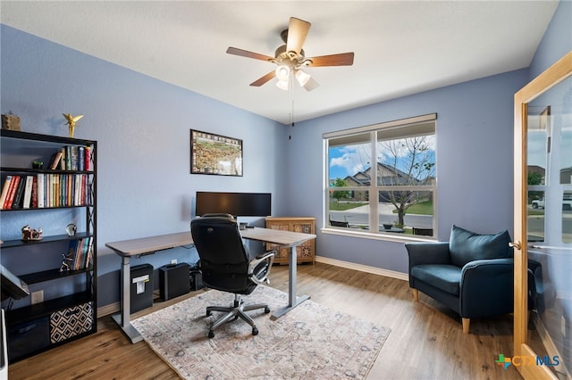 home office with wood finished floors, baseboards, and ceiling fan
