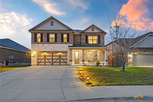 view of front of house featuring concrete driveway, a front lawn, covered porch, a garage, and brick siding