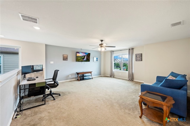 office space featuring visible vents, carpet flooring, baseboards, and ceiling fan