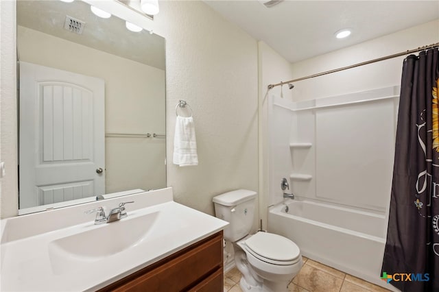 full bathroom with tile patterned floors, shower / bath combination with curtain, visible vents, toilet, and vanity