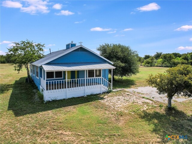 view of front of property with covered porch and a front yard