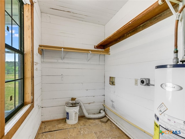 bathroom featuring water heater, wooden walls, and wood ceiling