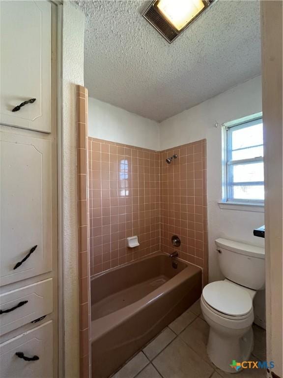 full bath featuring visible vents, shower / bathing tub combination, a textured ceiling, tile patterned floors, and toilet