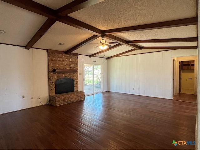 unfurnished living room with a textured ceiling, wood finished floors, a fireplace, ceiling fan, and vaulted ceiling with beams