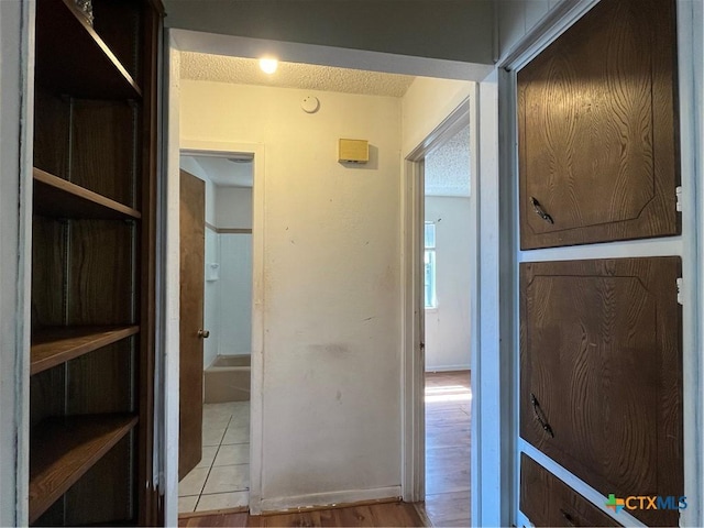 corridor with a textured ceiling