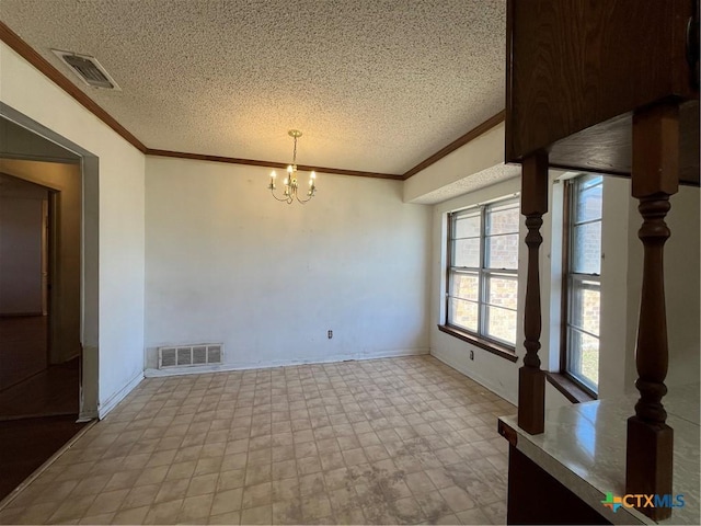 spare room with an inviting chandelier, crown molding, visible vents, and a textured ceiling