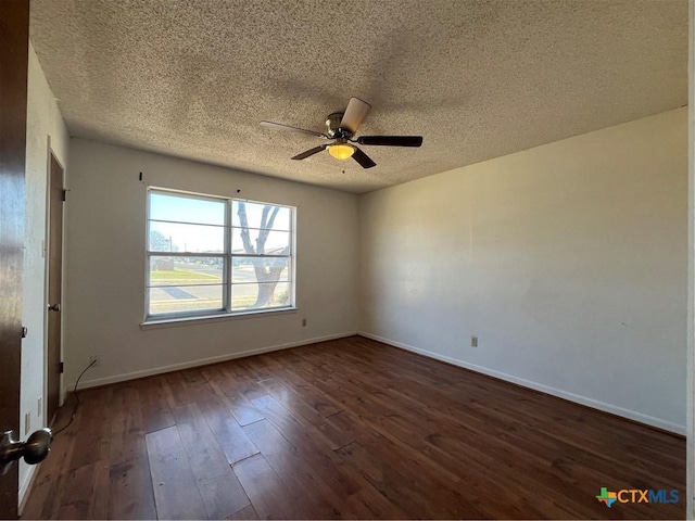 empty room featuring dark wood-style floors, a textured ceiling, a ceiling fan, and baseboards