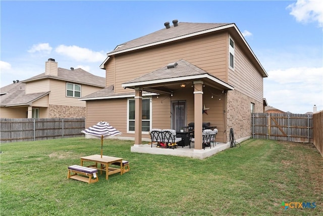 810 Mclaury Cv, Killeen, TX 76542 - rear view of house with a patio, a fenced backyard, a lawn, and brick siding