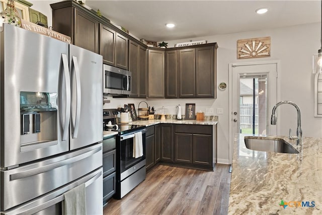 810 Mclaury Cv, Killeen, TX 76542 - kitchen featuring light stone counters, a sink, appliances with stainless steel finishes, and dark brown cabinets