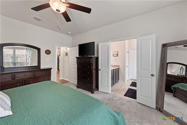 810 Mclaury Cv, Killeen, TX 76542 - bedroom with ceiling fan, light colored carpet, visible vents, baseboards, and connected bathroom
