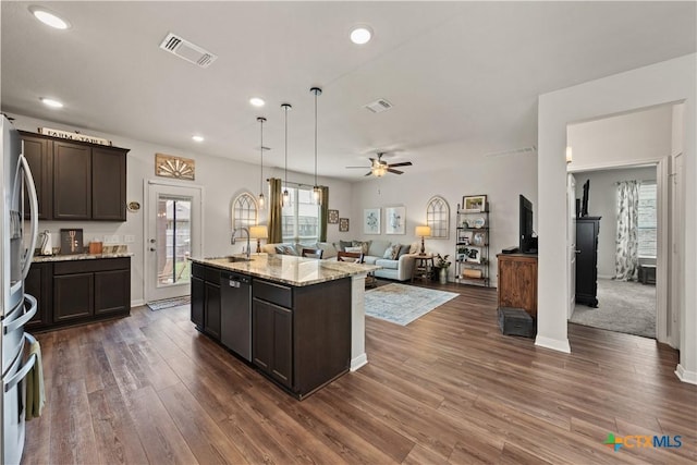 810 Mclaury Cv, Killeen, TX 76542 - kitchen with visible vents, open floor plan, dark brown cabinetry, and stainless steel appliances