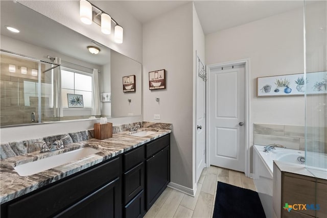 810 Mclaury Cv, Killeen, TX 76542 - bathroom featuring a garden tub, a sink, a stall shower, and double vanity