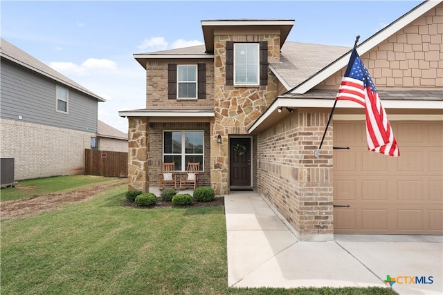 810 Mclaury Cv, Killeen, TX 76542 - traditional home featuring fence, an attached garage, a front lawn, brick siding, and stone siding