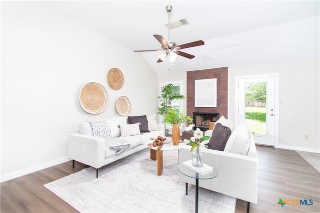 1418 Cedar Ln, Temple, TX 76502 - living area featuring wood finished floors, ceiling fan, baseboards, lofted ceiling, and a brick fireplace