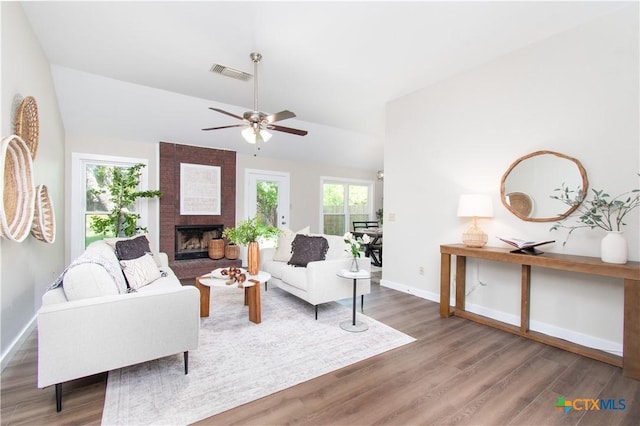 1418 Cedar Ln, Temple, TX 76502 - living room with wood finished floors, baseboards, vaulted ceiling, a fireplace, and ceiling fan