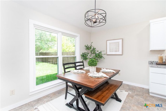 1418 Cedar Ln, Temple, TX 76502 - dining area with a chandelier, baseboards, and light stone finish flooring