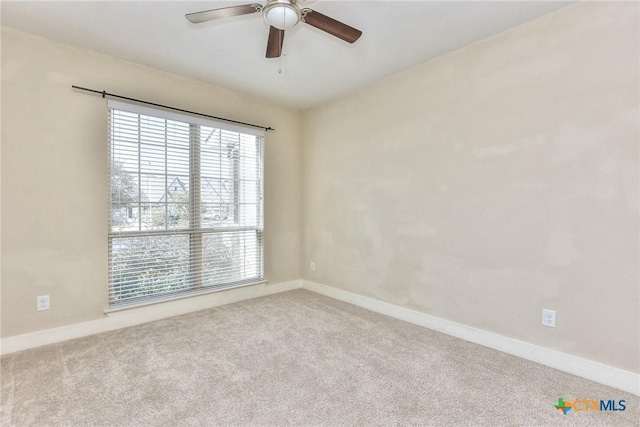 carpeted empty room featuring ceiling fan