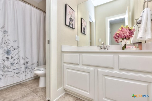 bathroom featuring toilet, vanity, a shower with curtain, and tile patterned flooring