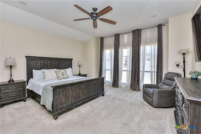 carpeted bedroom with ceiling fan and lofted ceiling