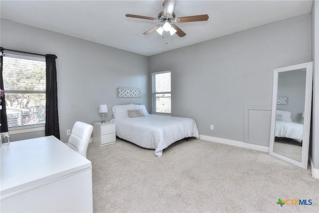 bedroom featuring ceiling fan and light carpet