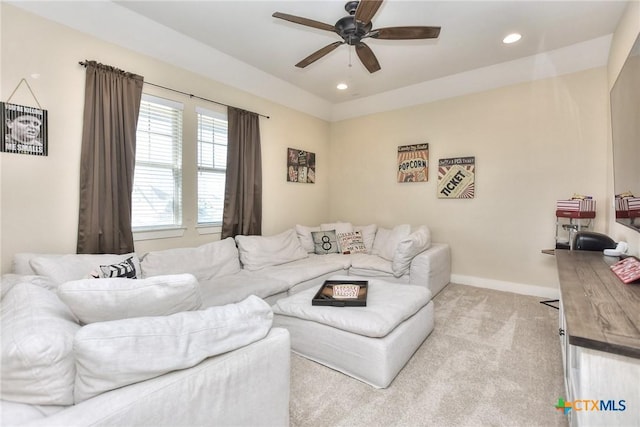 carpeted living room featuring ceiling fan