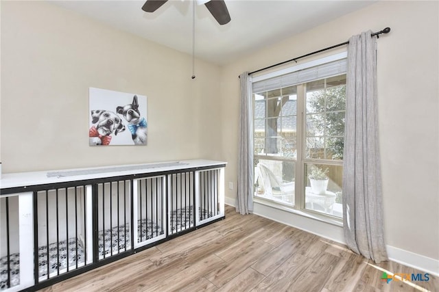 empty room with light hardwood / wood-style floors and ceiling fan