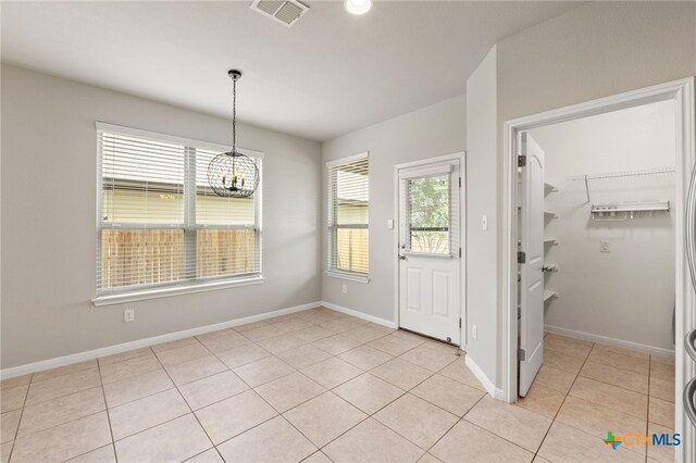 1904 Garretts Way, Manchaca, TX 78652 - unfurnished dining area featuring baseboards, light tile patterned flooring, a chandelier, and visible vents